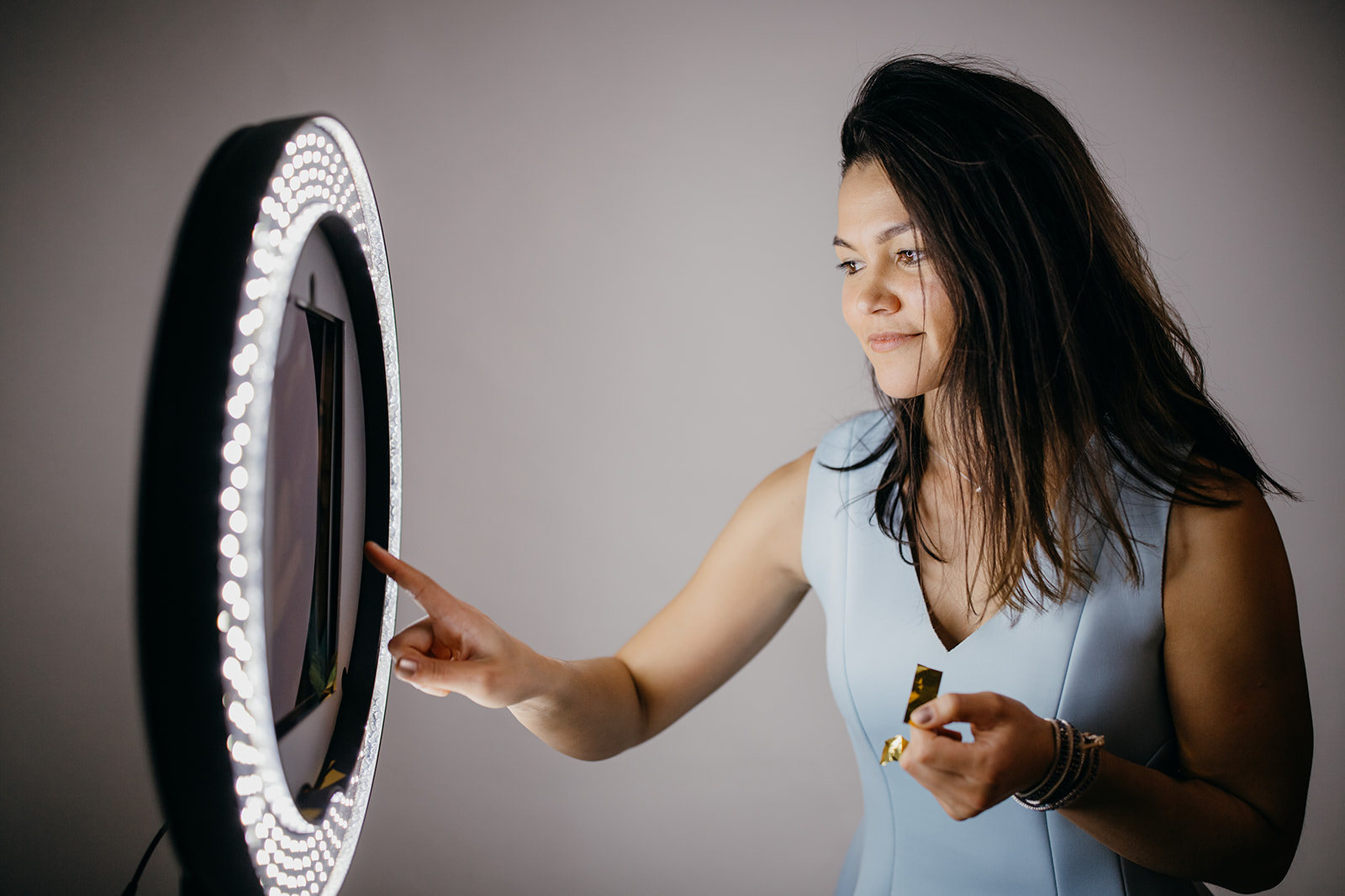 A woman enters her phone number into the Gifyyy photo booth